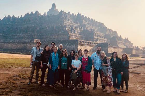 Photo of a group of 2024欧洲杯官方投注 students posing in front of a building in Indonesia